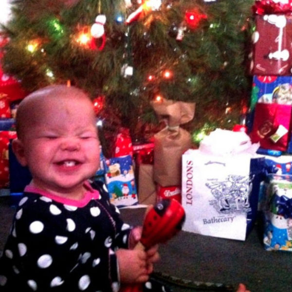 baby girl enjoying her first Christmas gifts!